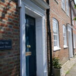 Amersham High Street with a building named The Old School House in the foreground